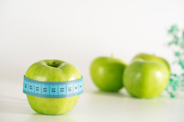 Green apple as a symbol of healthy and sports nutrition and weight loss.