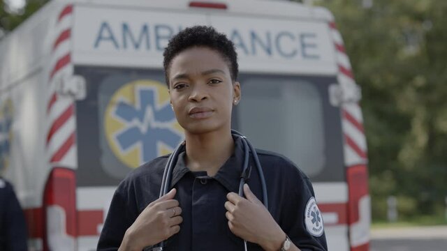 African american female paramedic in uniform posing outdoors