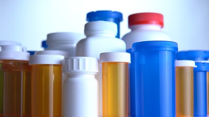 Various pills bottles macro close up shot. Production of medicines bottles. Pharmaceutical concept of healthcare, pharma industry, medication and drugs production. Medical research and trials.