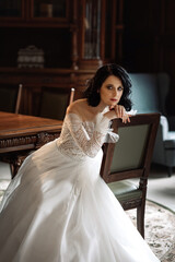 Naklejka premium bride in a wedding dress sitting on a chair