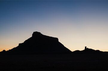 Silhouette of Factory Butte in Utah at dawn