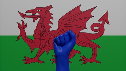 Fototapeta premium A single raised blue fist in the center in front of the flag of Wales