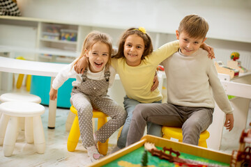 Group of kindergarten kid friends sitting and having fun