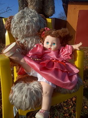 abandoned unnecessary doll in a beautiful pink dress 