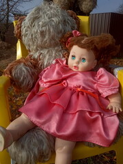 abandoned unnecessary doll in a beautiful pink dress
