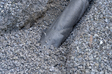 Drainage system - pipe, gravel, geotextile.
