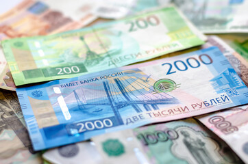 A Russian banknote with a face value of 200 and 2000 rubles lying on the money. The concept of finance, investment, savings and cash.