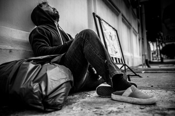Asian man is homeless at the side road,A stranger has to live on the road alone because he has no...
