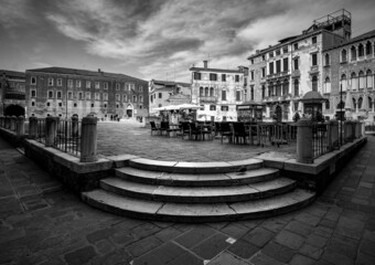 Black and white Venice. View of the old town square and stairs. Venice without water. Italy. Veneto.