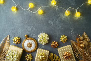 Flat lay background for Christmas holiday  with gift boxes and creative golden decorations. Palm leaves and pineapple creative ornament