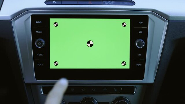 Keyed green screen chroma key mock up background. Unrecognizable male man hand doing different gestures for touch screen slide scroll on screen monitor on modern luxury car. Interface concept