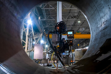 Submerged welding. Automatic welding. Automated pipe welding process by welding column.