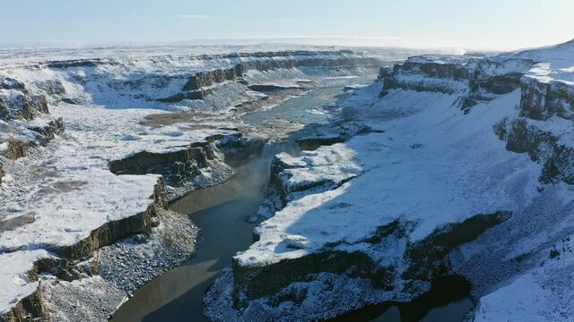 Hafragilsfoss waterfall with snow in autumn aerial view, Iceland