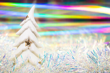 Fairy Christmas background with snowy fir tree and holographic background, copy space for text