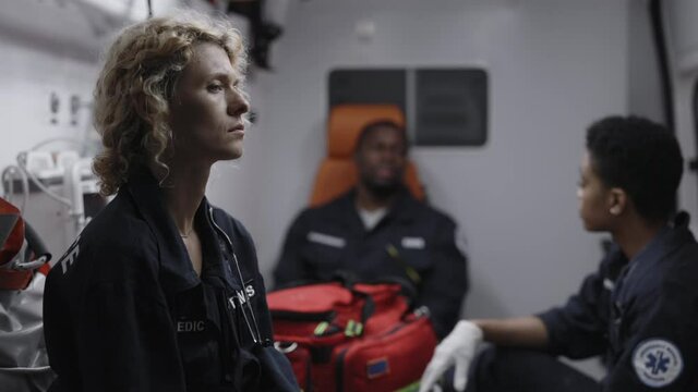 Caucasian paramedic trying to relax on way to emergency
