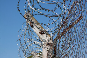 Prision. Barbed wire. Wire fence. Jail. Confinement. Security. Restricted access to enter or exit....