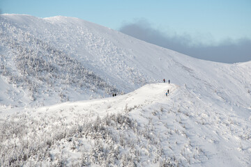 People hiking the Vallieres-de-St-Real mountain range during a wonderful winter day, Gaspesie,...