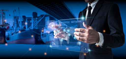 Businessman employing screen for logistic network distribution,smart transportation,and network intelligent logistics of truck and railway container cargo ships,logistic import-export,and industrial.