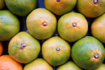 yellow ripe tangerine at turkish market close up background