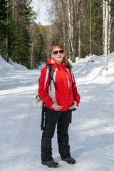 A woman in a winter tracksuit is tired on the road.