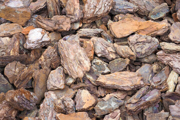 Pine wood bark nuggets. Wood bark chips texture. Mulching, pine bark mulch background