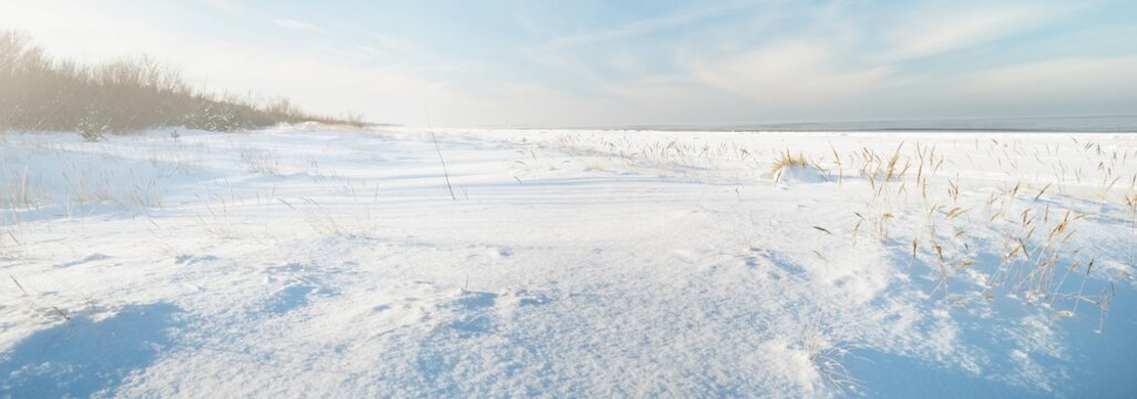 Frozen Baltic sea shore on a clear day, snow texture close-up. Blue sky. Picturesque winter scenery. Concept image. Seasons, nature, ecology, environment, climate change, global warming
