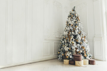 Classic christmas New Year decorated interior room New year tree. Christmas tree with gold...