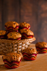 Freshly baked homemade muffins with raisins and carrots. Vegetarian pastries on a wooden background.