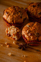 Homemade muffins on a wooden cutting board. Traditional festive Christmas baking.