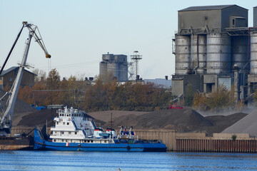 Fototapeta premium River port. A tug with a barge stands on the river near the pier. Nizhny Novgorod