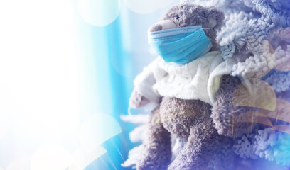 Toy bear in mask to prevent virus spread. Copy space. Teddy bears wearing protective mask. Coronavirus protection.
