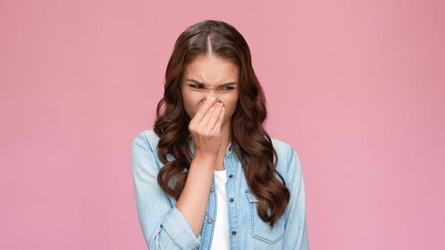 Irritated annoyed lady express disgust displeasing smell