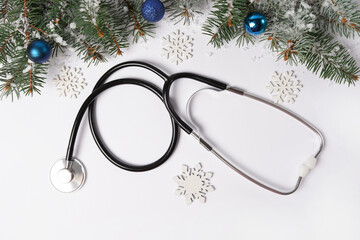 Celebrating Christmas in the healthcare industry. Stethoscope with ornaments and snowflakes on...