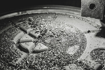 Chips after processing the cast iron hatch on the carousel machine in the workshop of the...