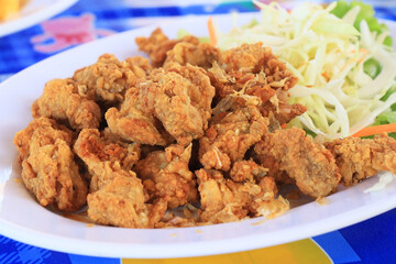 Fried chicken on plate decorated with vegetables