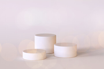 3d render of three white podiums. Minimalistic scene for cosmetics or product presentation template. Different pedestals or platforms with bokeh lights for premium and luxury advertising. Blank space