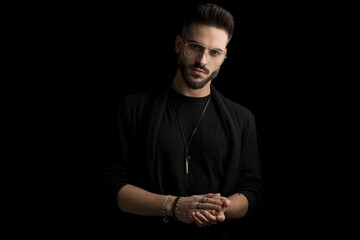 attractive bearded young man with eyeglasses rubbing palms