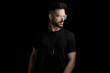 cool bearded man wearing glasses and looking to side