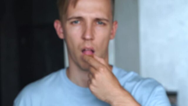 Portrait of young man showing close omega vitamin fish oil nutritional capsule medicine painkiller pill. stressed person taking antidepressant supplement with water.men health care,pharmacy, treatment