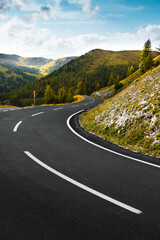 Scene of asphalt road between green mountains