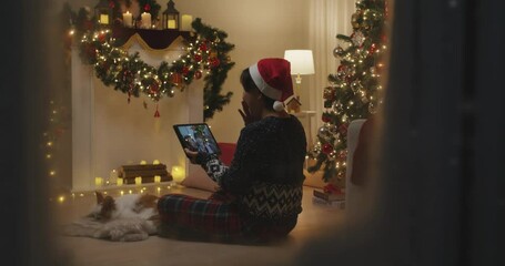 Candid asia mature adult people woman relax smile laugh greet in digital tablet screen remote talk to friend at night online video call VoIP Merry Xmas eve party sit at cozy home enjoy winter season. - Powered by Adobe