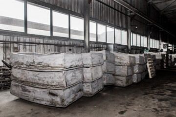 Cast iron tubing reinforced concrete cast products for lining distillation tunnels and underground structures are stored in the warehouse of the industrial plant