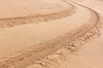 Traces of car wheels in the sand. Close-up, selective focus