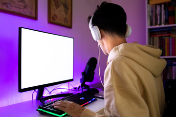 Fototapeta premium Young man playing multiplayer online games on computer.
