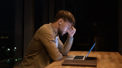 Anxious stressed young businessman employee manager stuck with difficult task, trying solving...