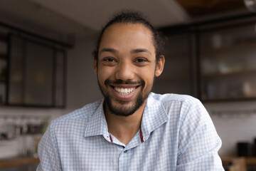 Head shot smiling young african american bearded man looking at camera, holding video call...
