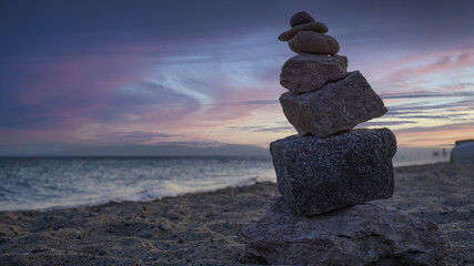 Balance of rock stones on beach, beautiful stones stacked on top of each other. Growing or going higher up concept photo. Blank or copy space on ocean sky.