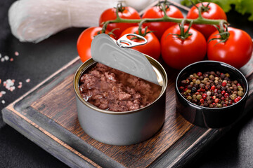 Canned delicious fresh tuna in oil with salt and spices in a tin can