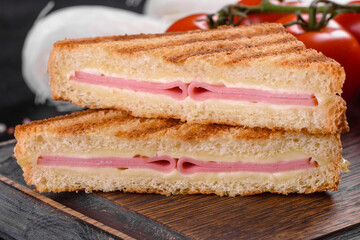 Sandwich with ham, cheese, tomatoes, lettuce, and toasted bread
