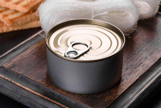 Canned delicious fresh tuna in oil with salt and spices in a tin can